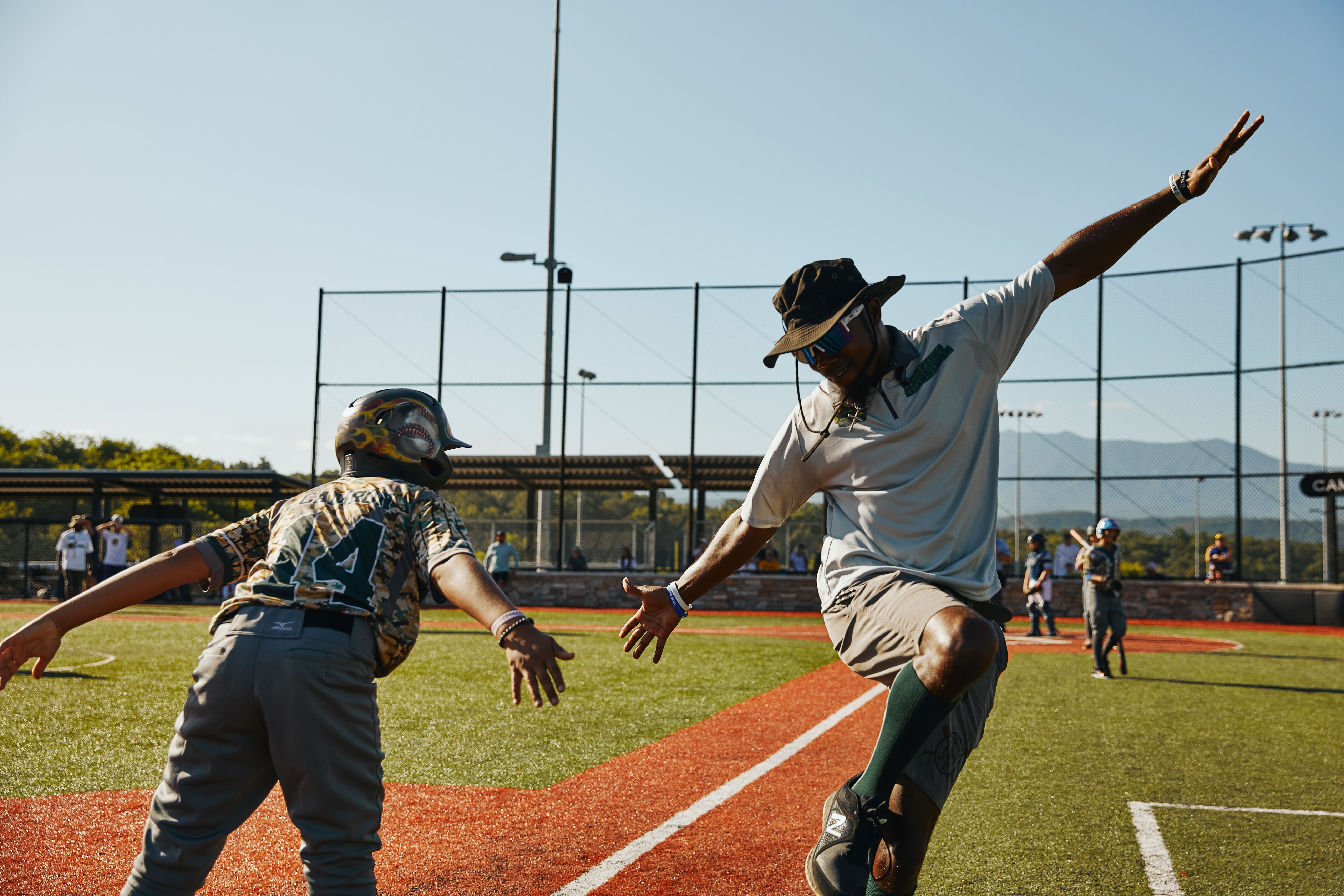 coach slapping hands with player at The Ripken Experience™ Pigeon Forge