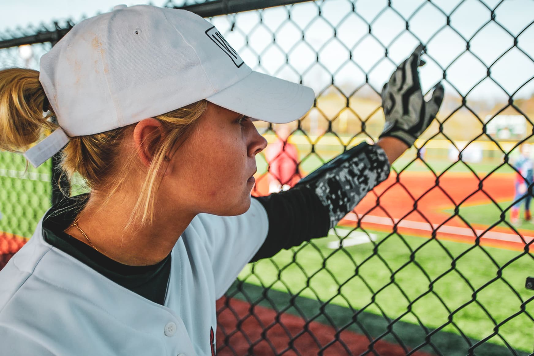 softball player in dugout at The Ripken Experience™ Myrtle Beach