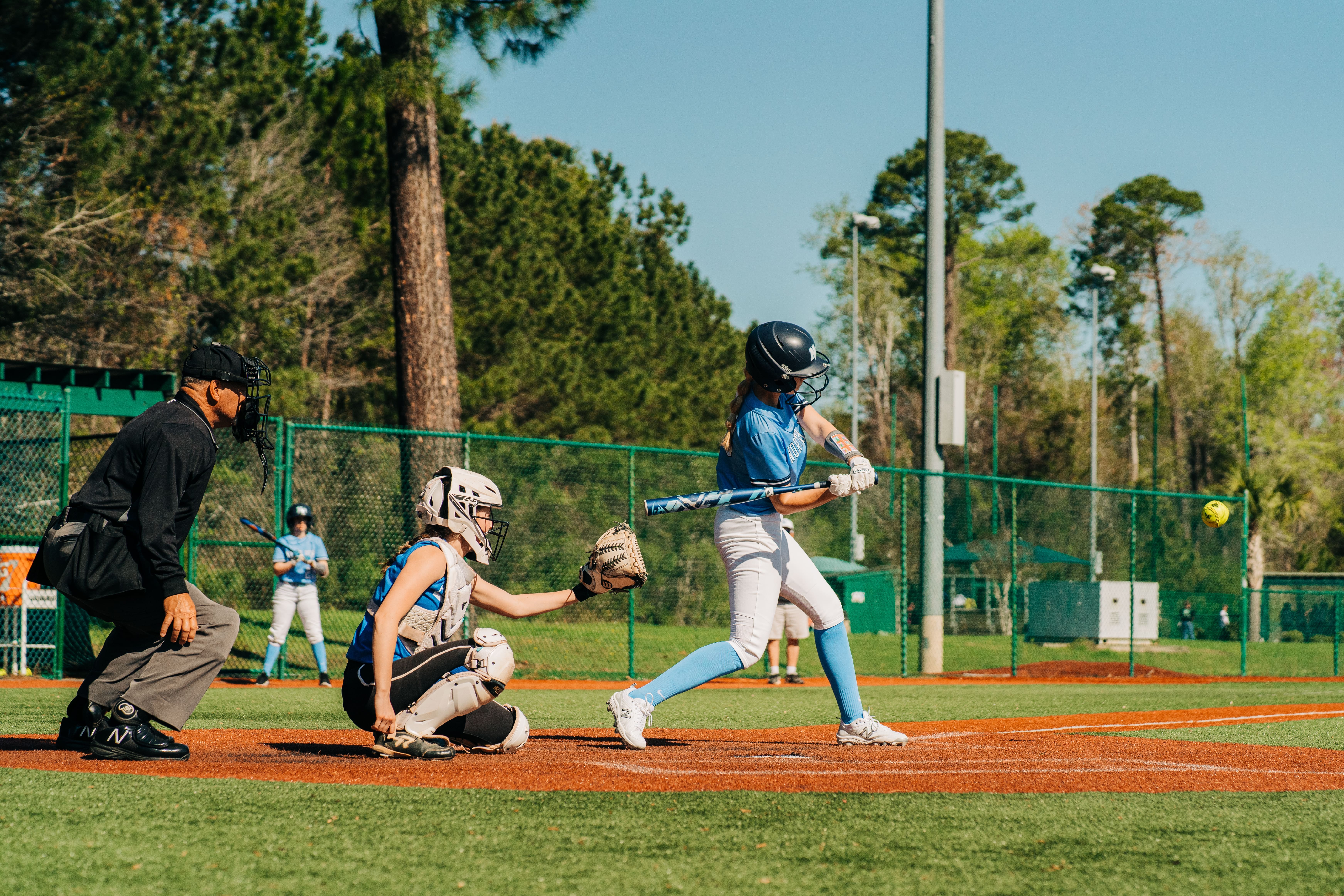 girl hitting softball at The Ripken Experience™ Myrtle Beach