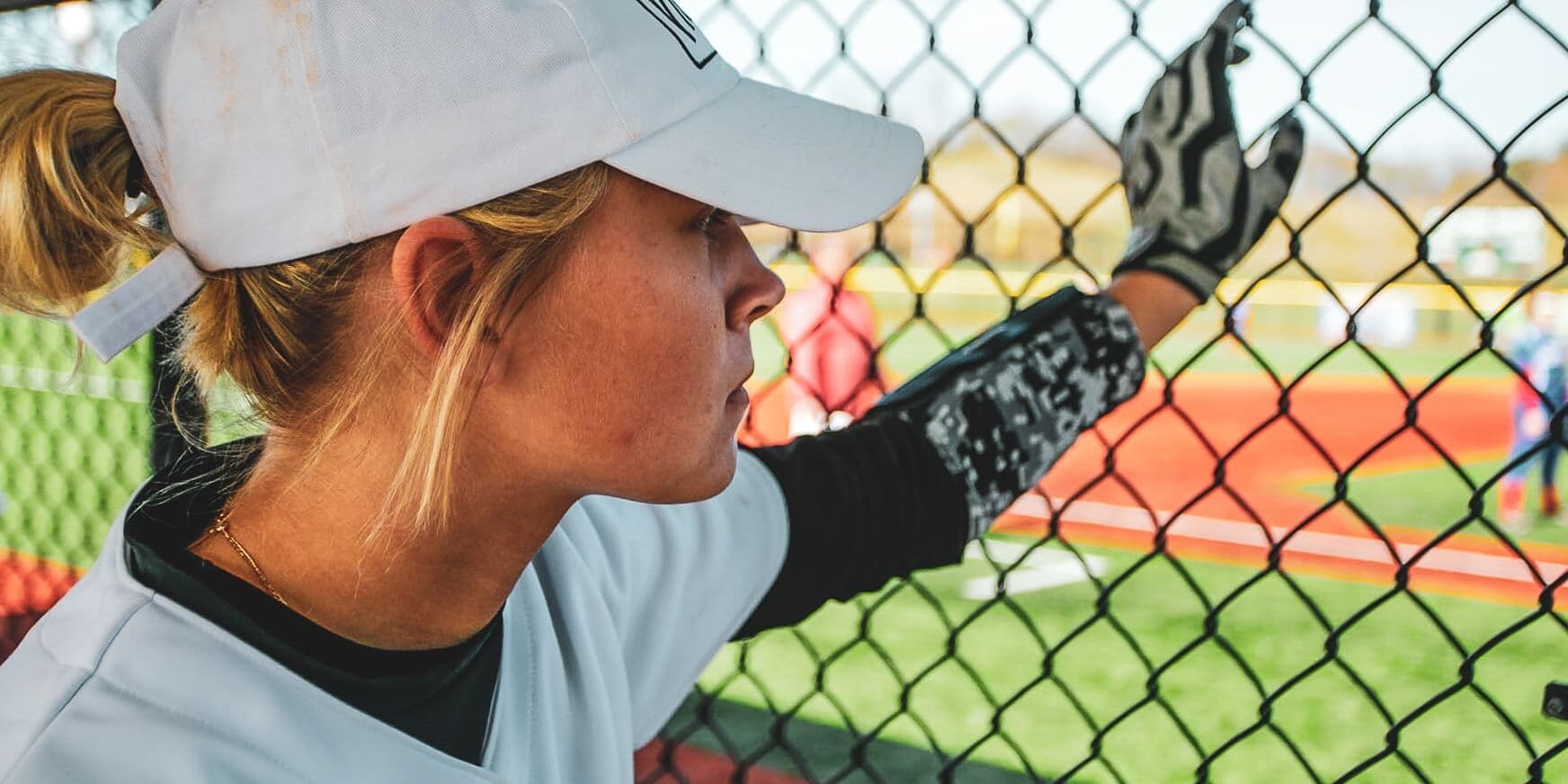 softball player in dugout at The Ripken Experience™ Myrtle Beach